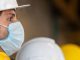 tradesperson on building site wearing coronavirus face mask